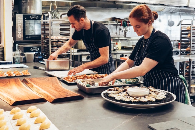 man-and-woman-wearing-black-and-white-striped-aprons